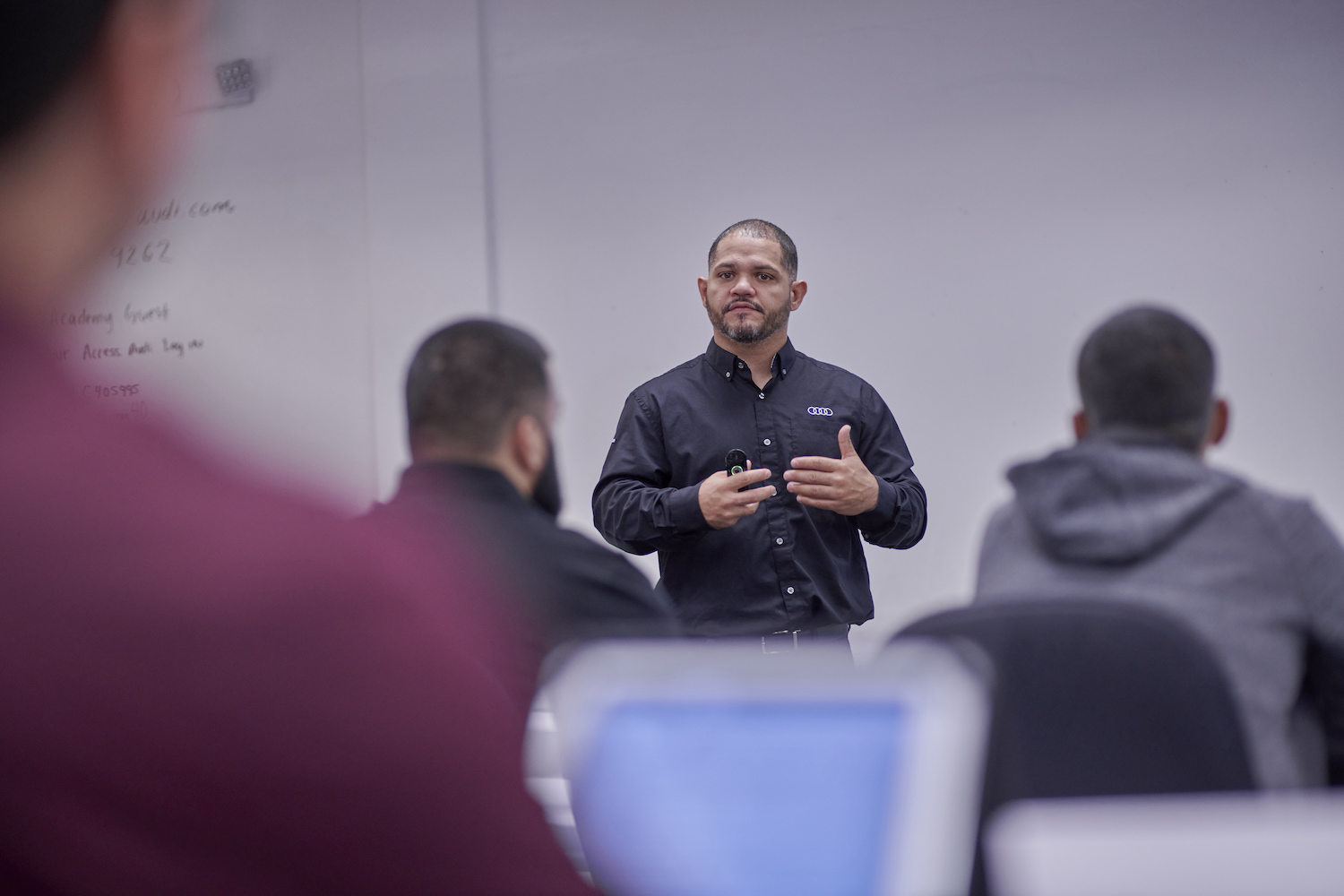 An Audi instructor addresses students in the Audi Education Partnership at an in-person session.